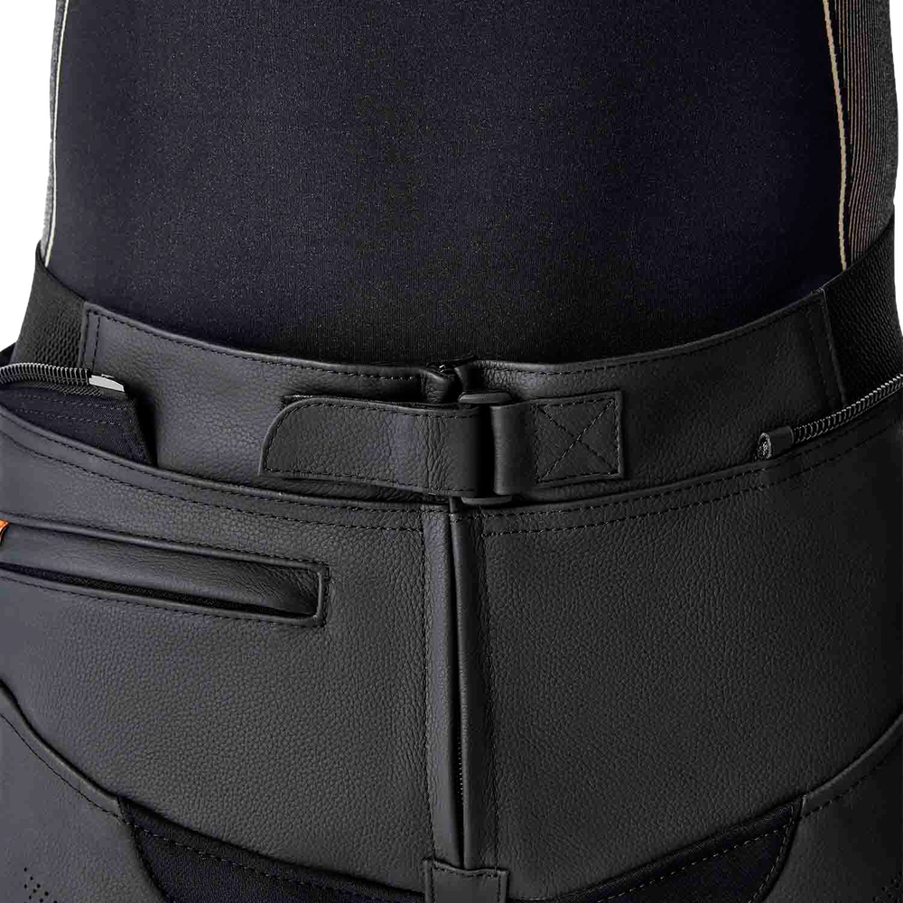 Close-up of black riding pants with a belt and visible stitching details.