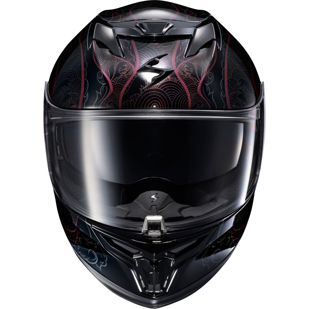 A full-face motorcycle helmet with a glossy black base, decorated with intricate red and gray dragon or snake-like patterns on the top and lower sides, featuring a dark tinted visor.