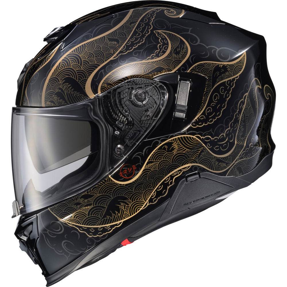 A full-face motorcycle helmet in glossy black with an elegant gold wave pattern, featuring a clear visor and a small red logo on the side.