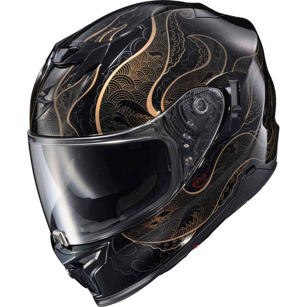 A full-face motorcycle helmet in glossy black with elegant gold wave patterns, featuring a clear visor, shown against a plain white background.