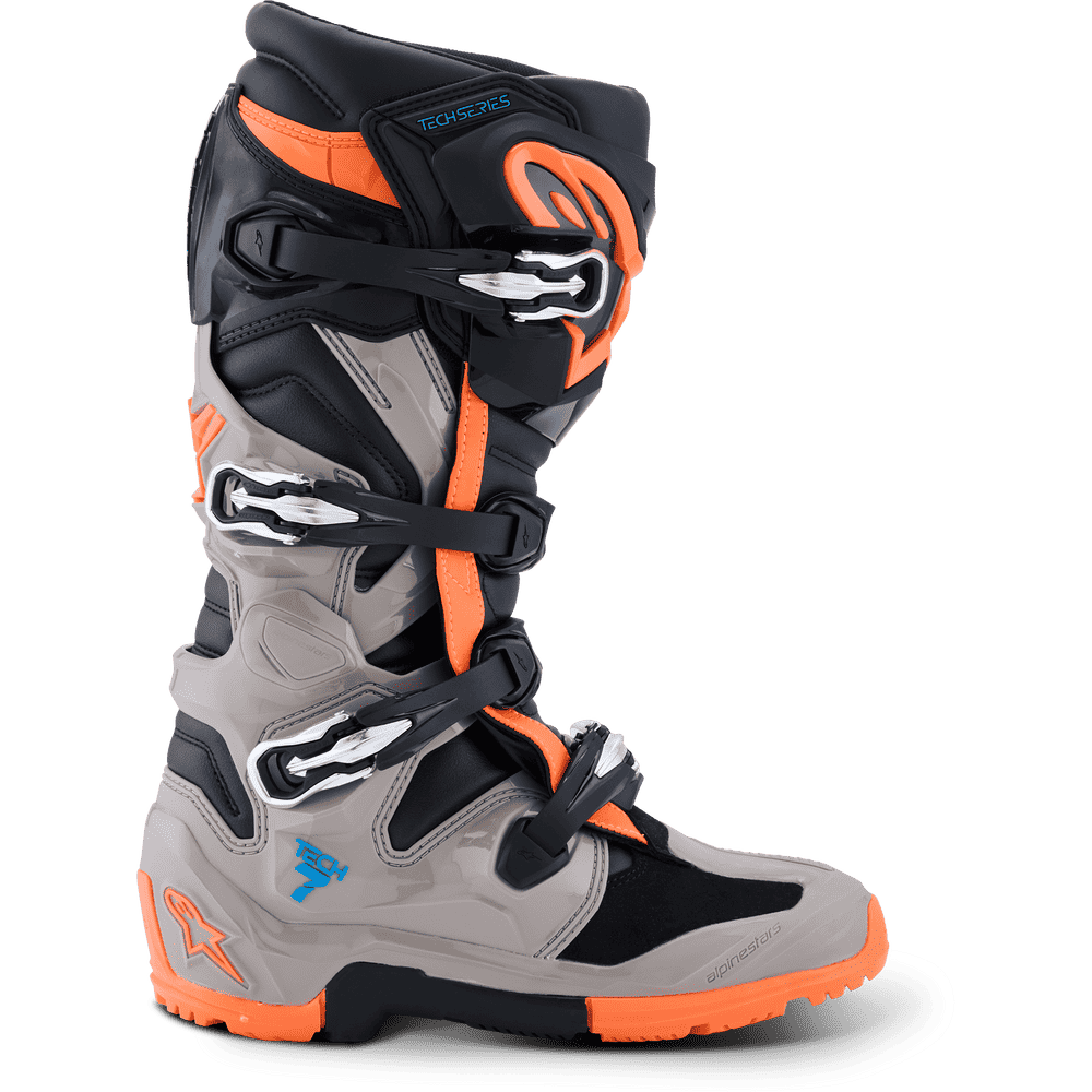 Alpinestars motocross boot in black, gray, and bright orange, shown from the side on a white background.