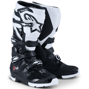 A pair of Alpinestars motocross boots in a Black/White colorway, featuring the signature white Alpinestars star logo on the side, set against a clean white background.