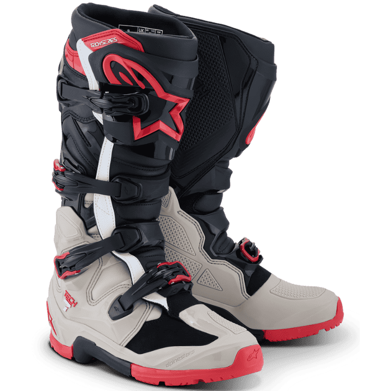 A pair of Alpinestars motocross boots in a Black/Light Grey/Bright Red colorway, featuring the signature white Alpinestars star logo on the side, set against a clean white background.