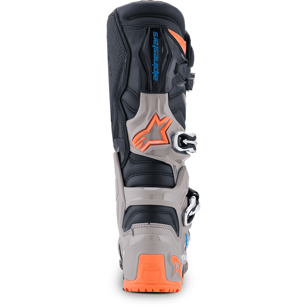 Alpinestars motocross boot in black, gray, and bright orange, shown from the rear three-quarter view on a white background.