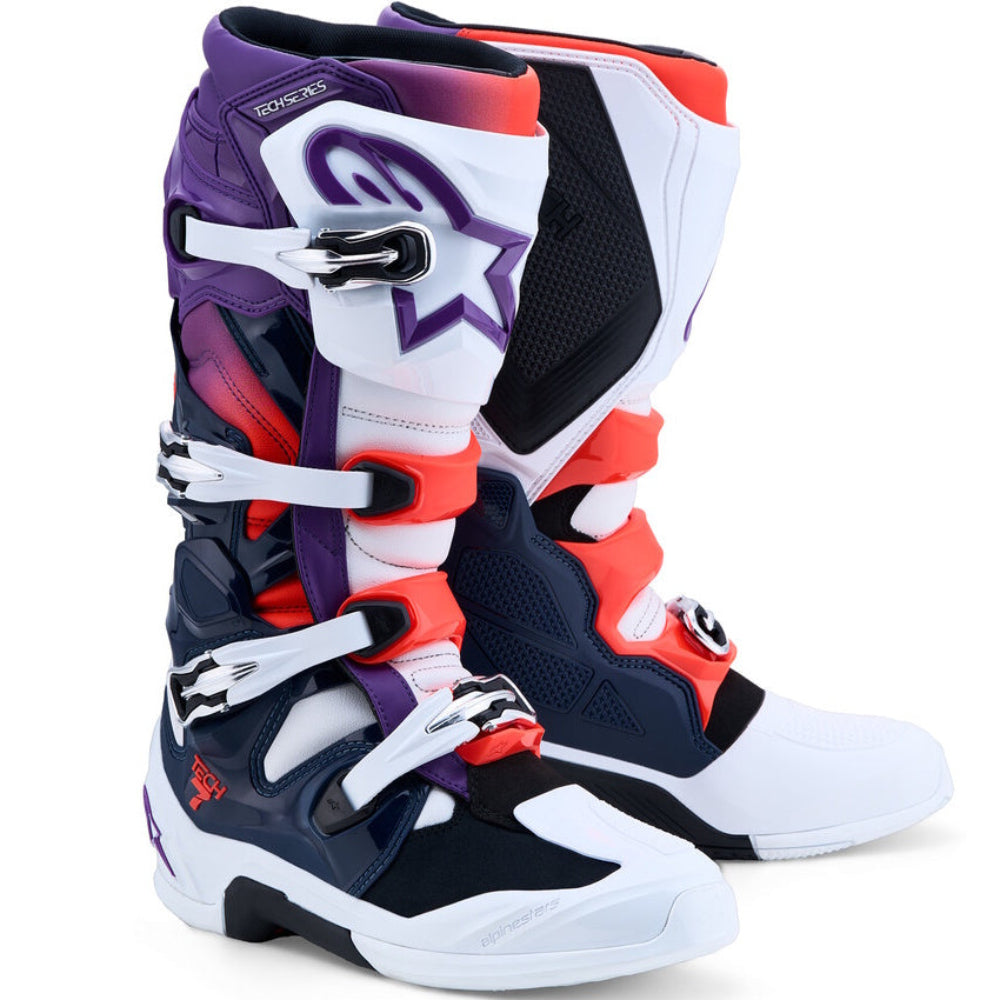 A pair of Alpinestars motocross boots in a colorway of navy blue, white, purple, and orange, shown on a clean white background.