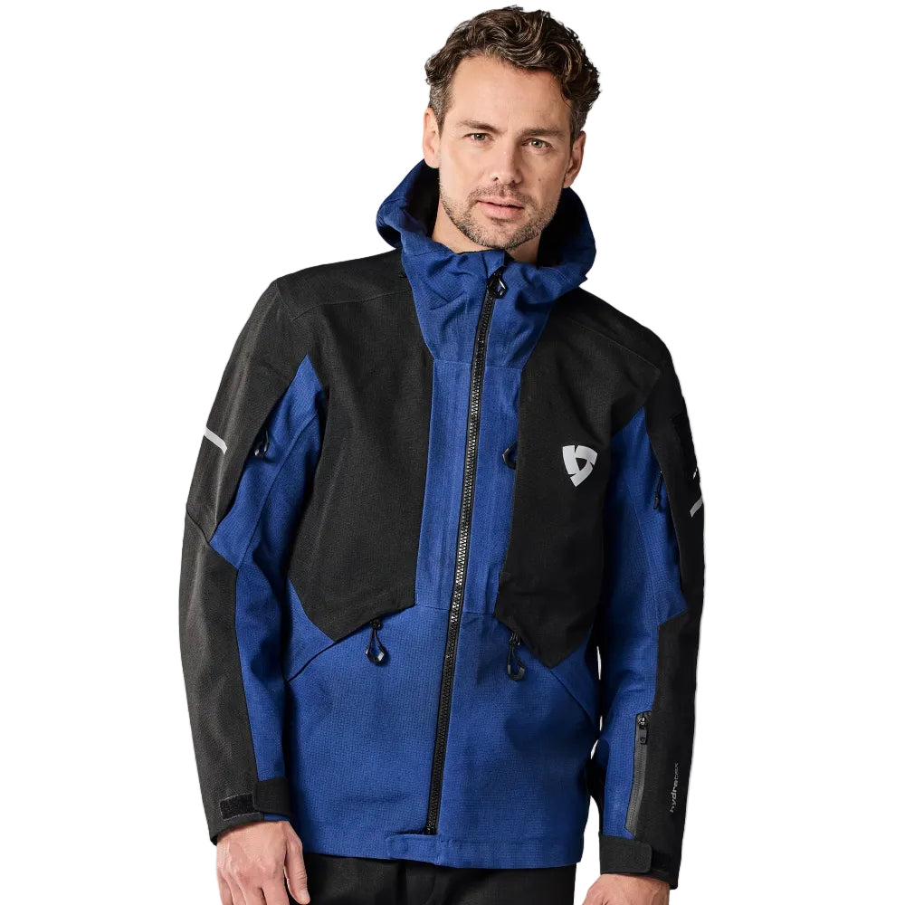 Man wearing a black and blue jacket on a white background