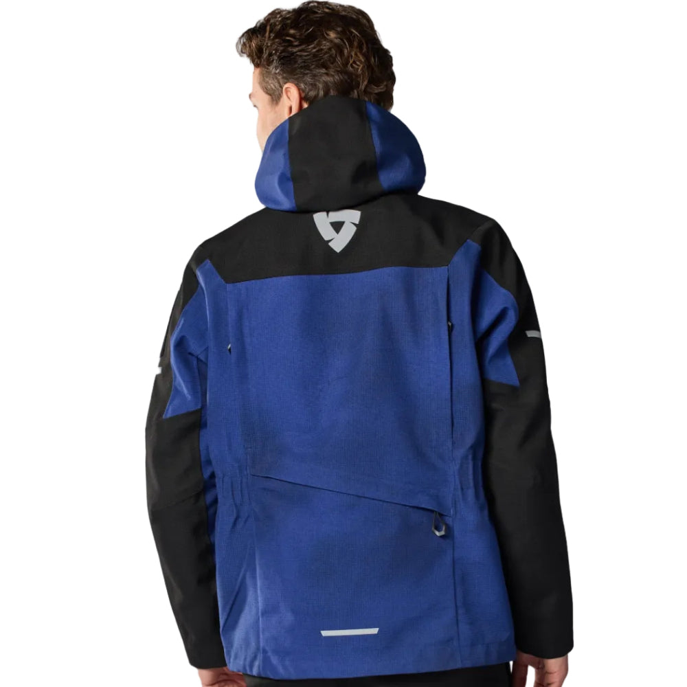 Person wearing a blue and black jacket on a white background