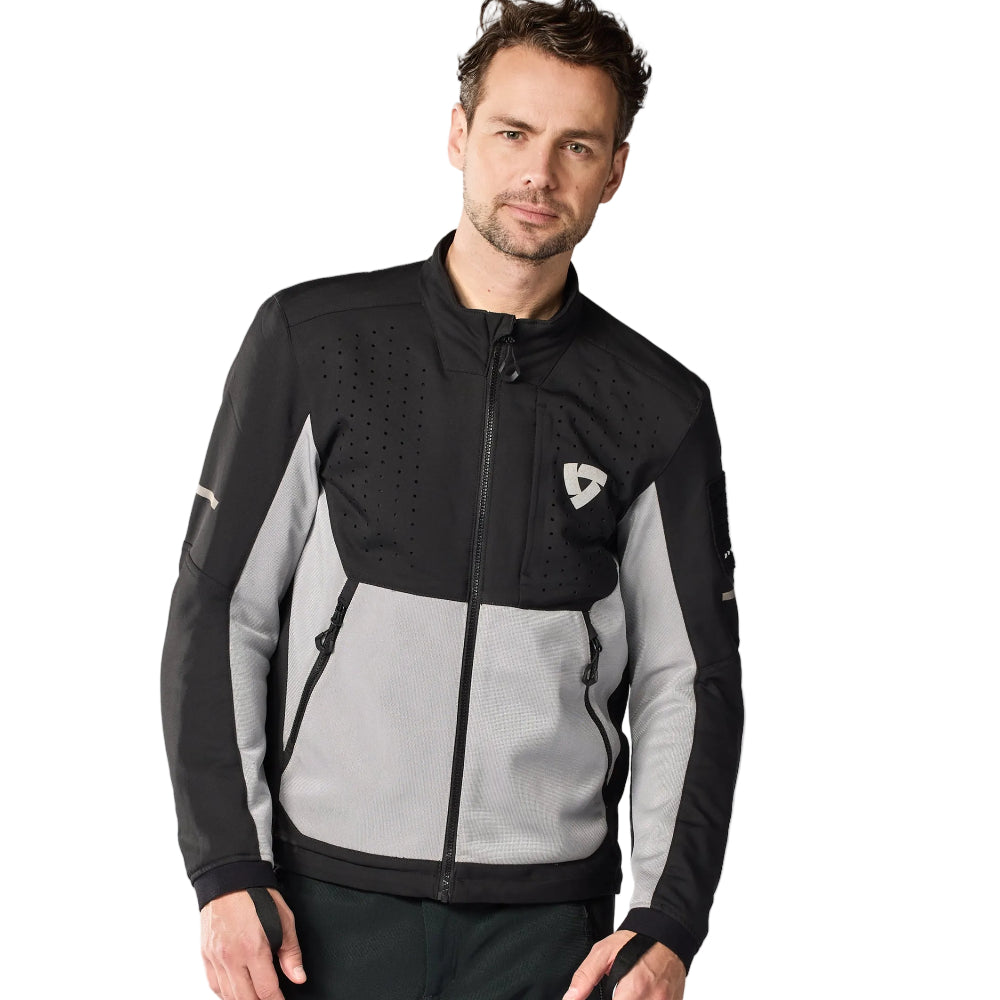 Man wearing a black and gray jacket with a logo on a white background
