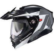 A Scorpion Exo AT960 modular full-face motorcycle helmet in black, white, and gray, featuring a clear visor and an open flip-up hood, shown against a plain white background.