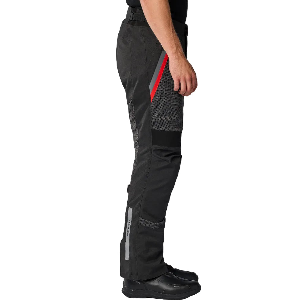 Person wearing black and gray pants with a red stripe on a white background