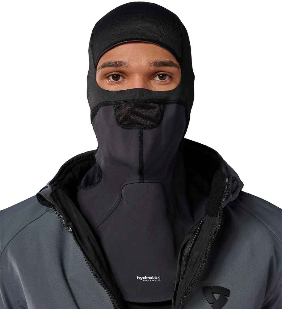 A man wearing a black full-head balaclava mask with a small mesh ventilation panel over his nose, paired with a dark gray hooded jacket. The brand name 'hydrox' is visible on the chest of the jacket.