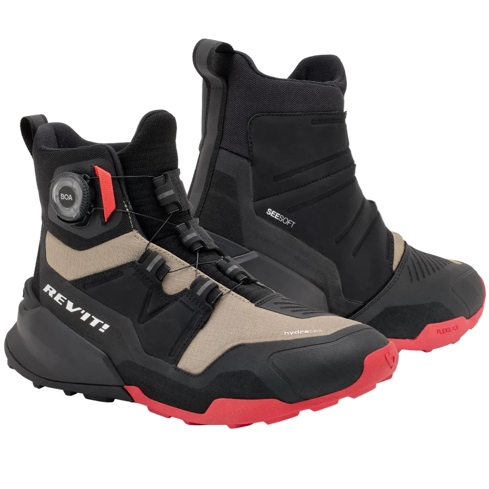 Black and beige boots with red accents on a light gray background