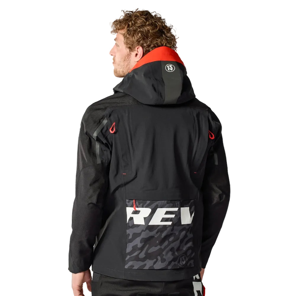 Person wearing a black jacket with a visible brand logo on the back, standing against a white background.