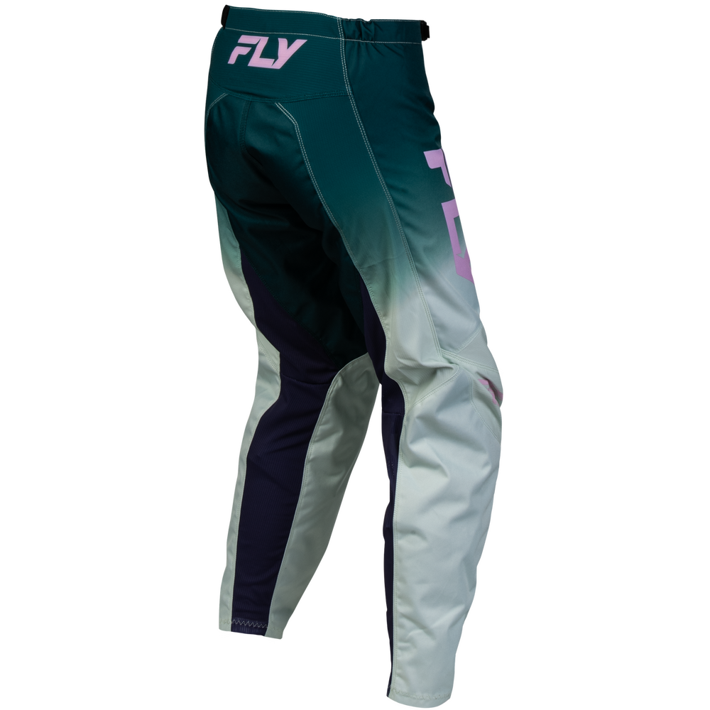Side view of motocross pants featuring a dark teal green to light gray gradient with dark navy side panels and light purple accents, including a visible 'FLY' logo on the waistband.