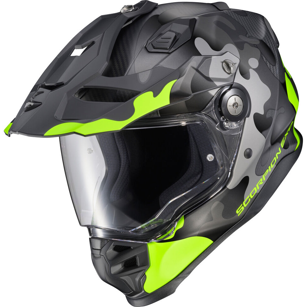 A Scorpion full-face motorcycle helmet in matte black and dark gray with bright neon green accents, featuring a clear visor, shown on a solid white background.