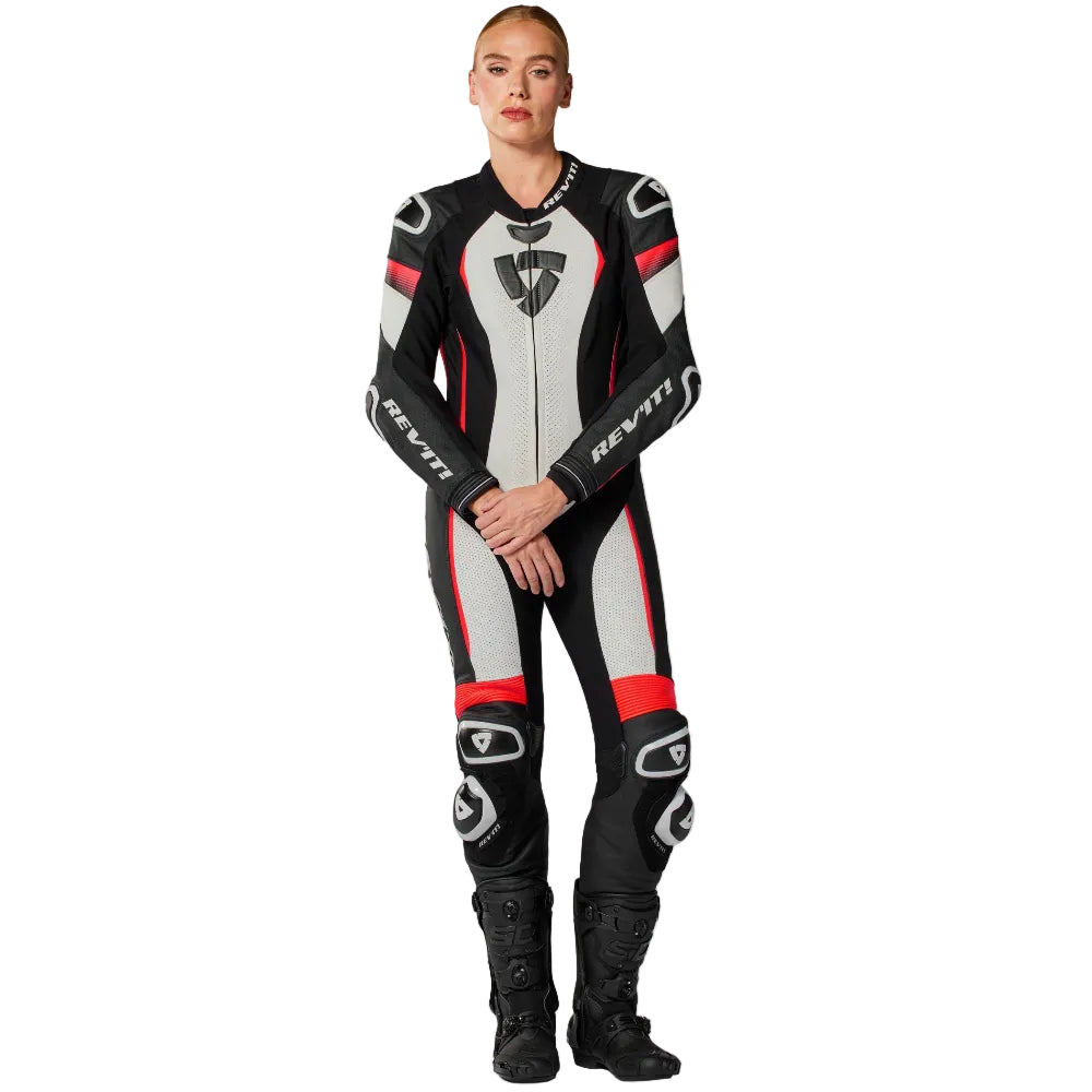 Person wearing a black, red, and gray motorcycle suit on a white background