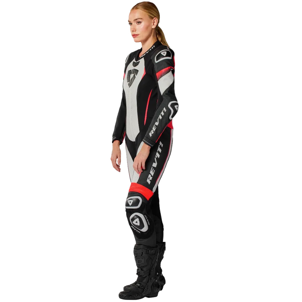 Person wearing a black and red motorcycle suit on a white background