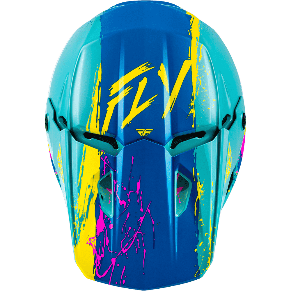 A top view of a motocross helmet with a vibrant blue and teal base, decorated with bold yellow and pink paint-splatter graphics and the 'FLY' brand logo on the forehead.