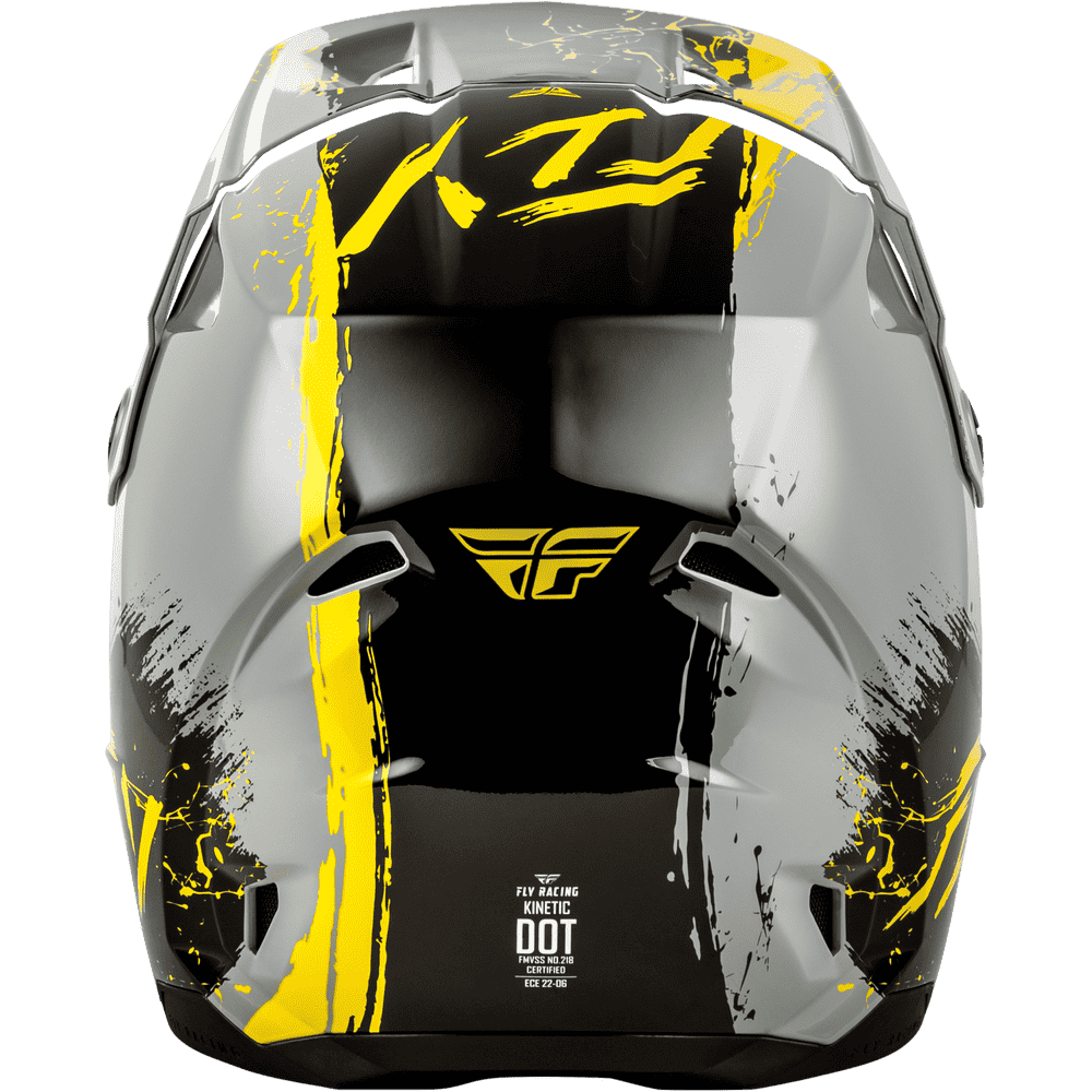 A close-up rear view of a full-face motocross helmet in glossy black and gray with bold yellow graphic stripes and splatter details, featuring the Fly Racing logo.