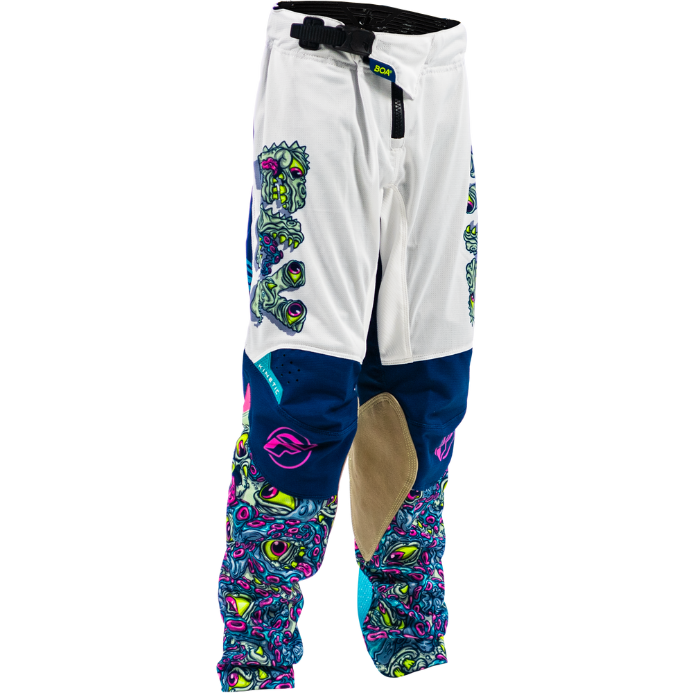 White motocross pants with colorful psychedelic graphics, navy blue knee panels, a beige abrasion patch, and a black drawstring waist.
