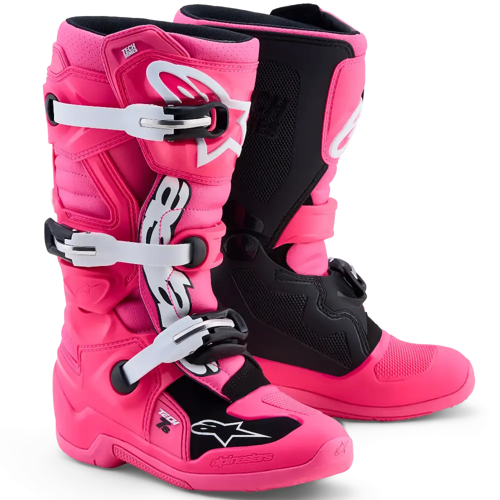A pair of Alpinestars pink motocross boots with black accents shown on a clean white background.