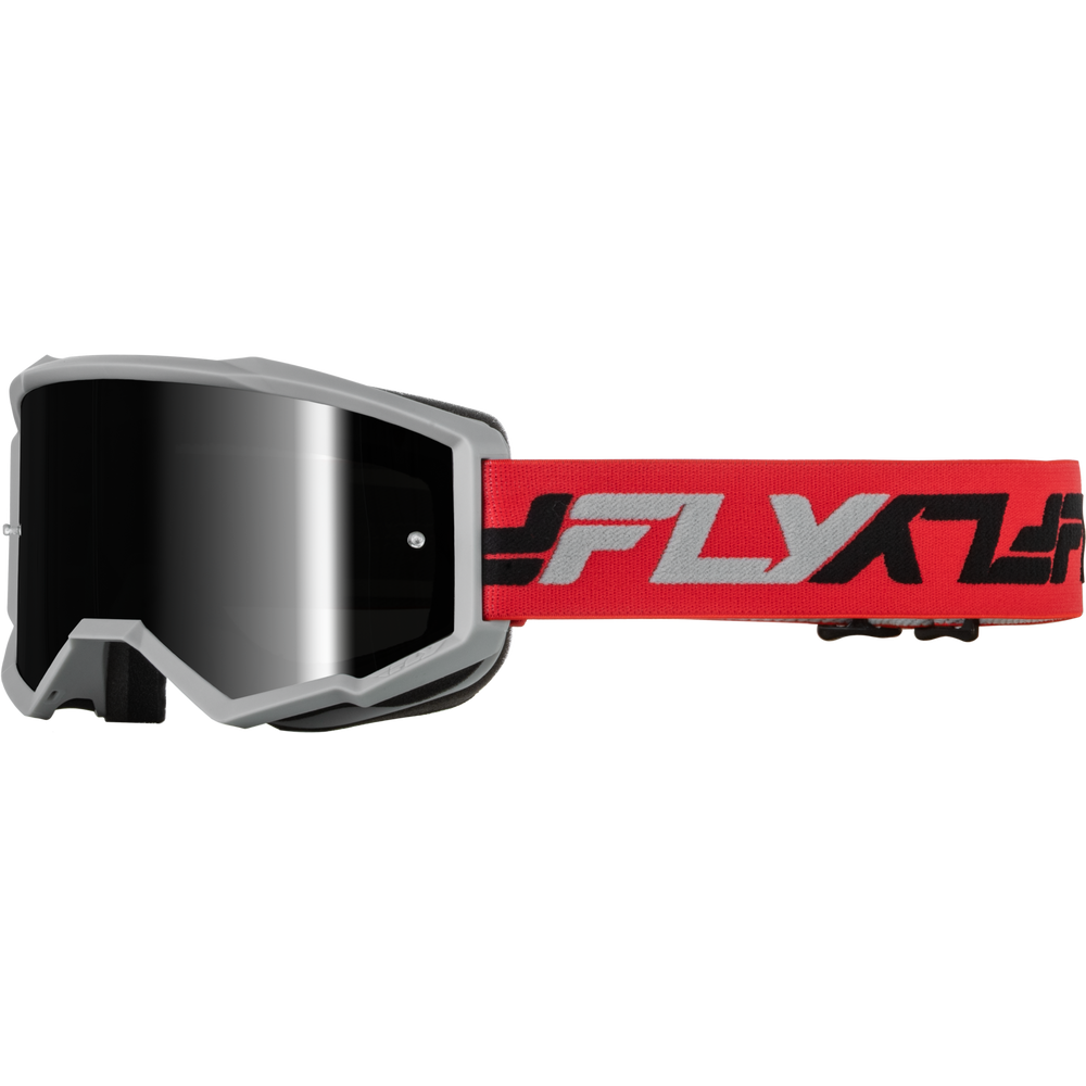 MotoGP goggles with a silver frame, a dark gray reflective lens, and a bright red strap featuring the 'FLY' brand logo in black and white.