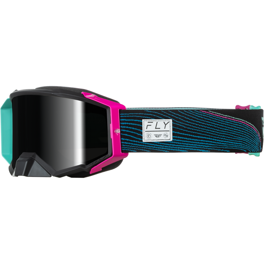 A pair of Fly Off-Road goggles with a black and pink frame, a dark reflective lens, and a patterned strap in teal and black with a pink accent.