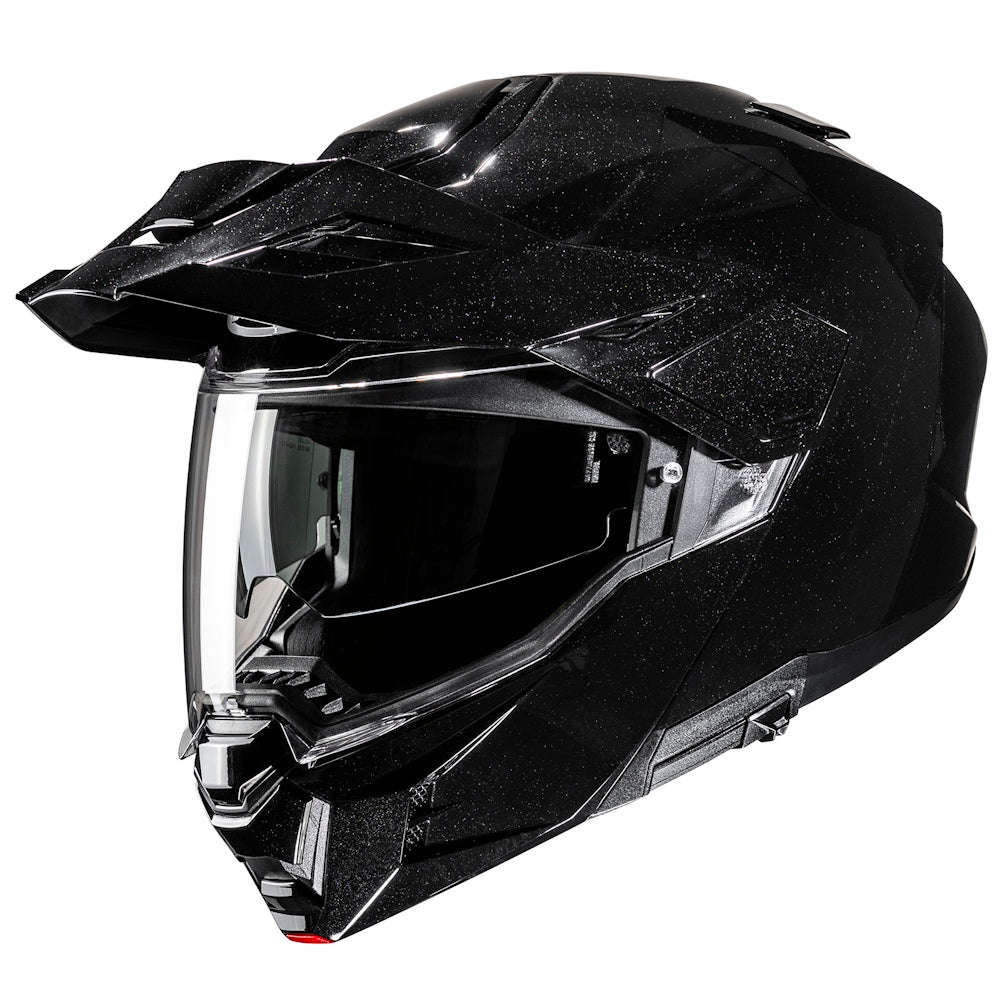 Black off-road helmet with clear visor on a white background