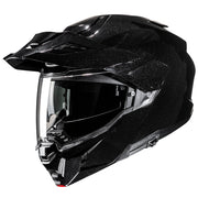 Black off-road helmet with clear visor on a white background