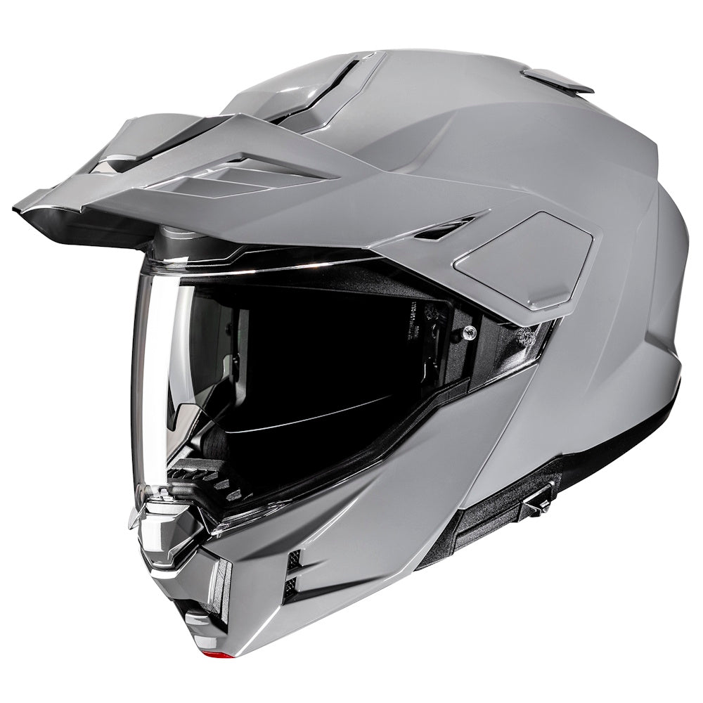 Grey motorcycle helmet with clear visor on a white background