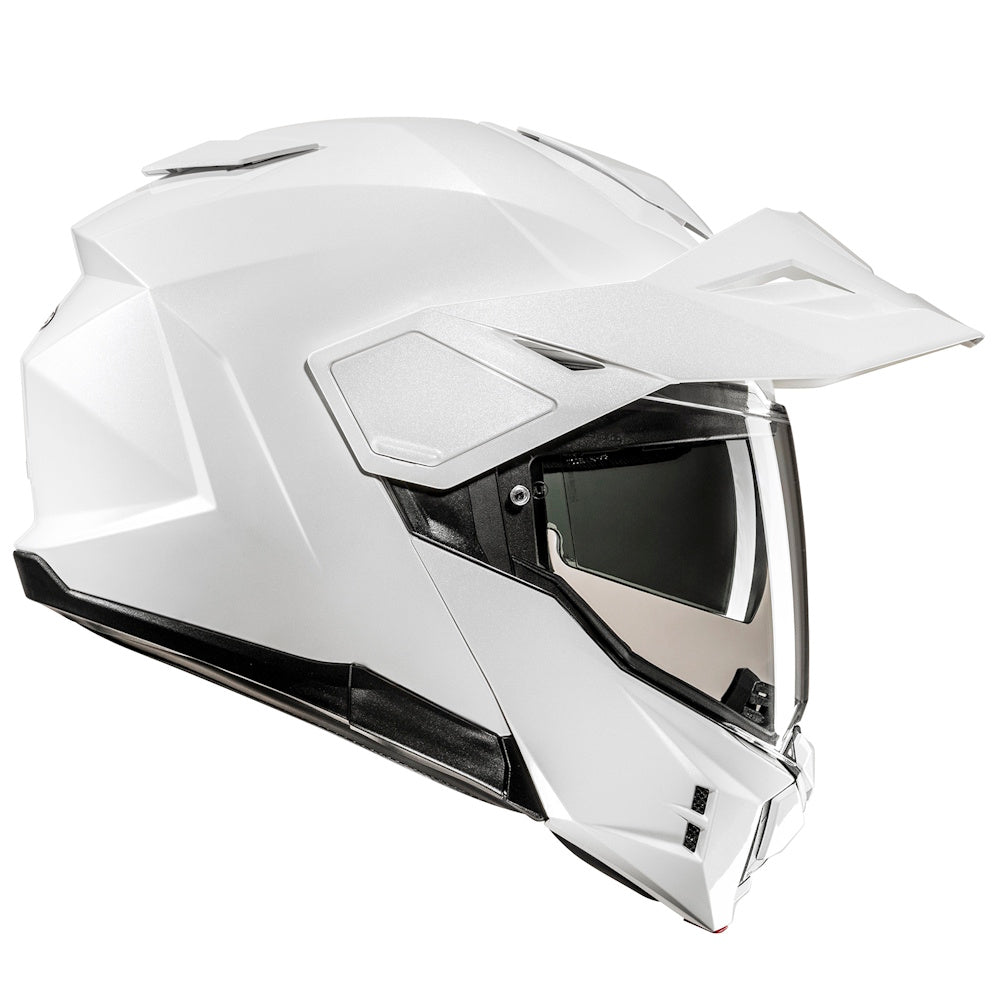 A white full-face off-road motorcycle helmet with a clear visor, shown from a three-quarters angle on a solid white background.